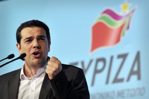 Left Coalition Party leader, Alexis Tsipras gestures while addressing his supporters, during party's main pre-election rally in central Athens Omonia square on May 3, 2012. The slogan reads' Turnout in Greece-message to Europe'.  Crunch elections in Greece on May 6 may not produce a government with a strong enough mandate to push through yet more austerity cuts to satisfy Athens' international creditors. Sunday's election is expected to see Greek voters, many of them fed up with grinding austerity drives, vote for parties that say they would scrap deals with the EU and IMF.  AFP PHOTO / LOUISA GOULIAMAKI        (Photo credit should read LOUISA GOULIAMAKI/AFP/GettyImages)